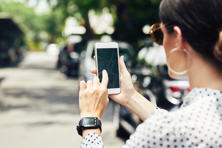 Close-up image of woman examining map in her navigation mobile application