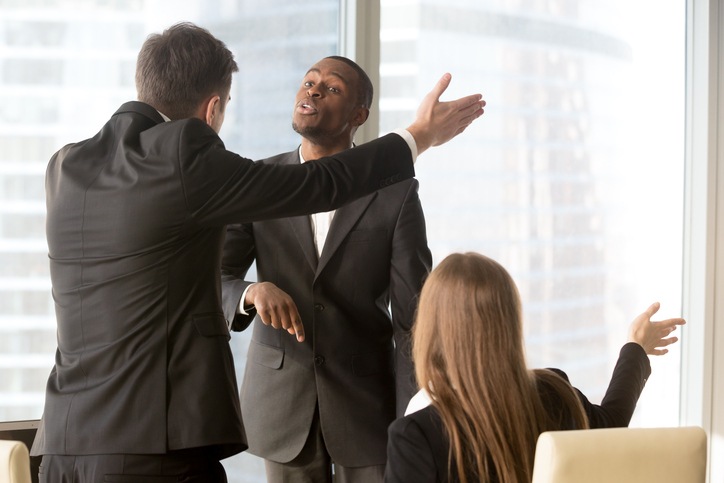 two men arguing in the workplace