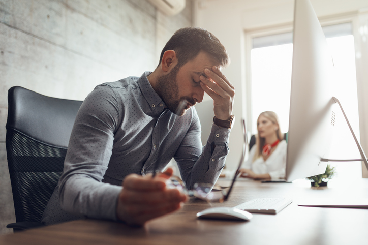 man at computer looking frustrated