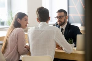 men and women sitting at a desk