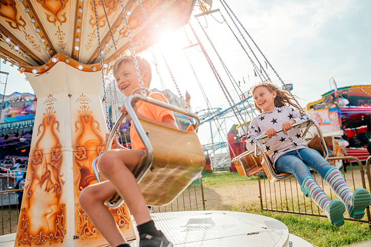 kids on theme park swings ride