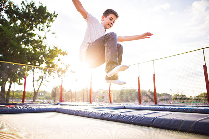 kid jumping on a trampoline